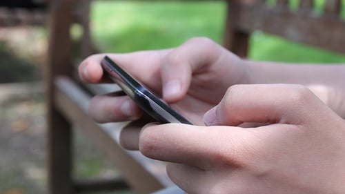 Close Up of Hands Using Smartphone