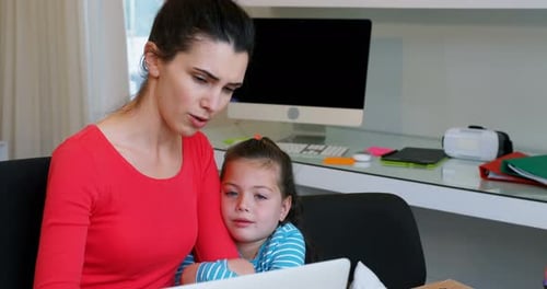 Woman and Child Working Together at Desk