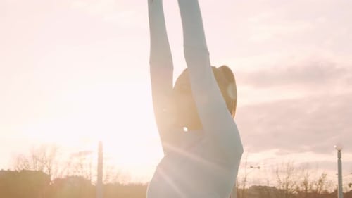 Woman Stretches Outside During Golden Hour