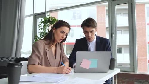 Man and woman work in comfortable modern office with laptop. Working process