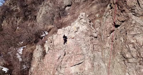 A Group of People are Engaged in Rock Climbing