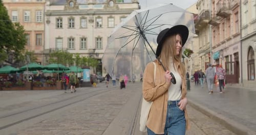The Girl is Opening Her Umbrella and Smiling