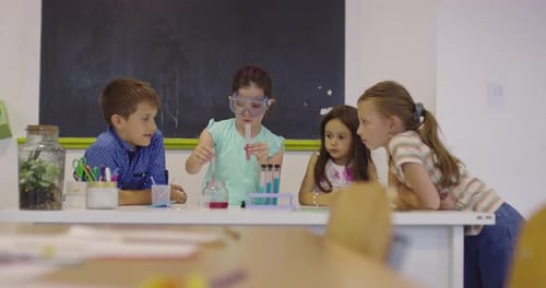 Elementary School Science Classroom Enthusiastic Teacher Explains Chemistry to Diverse Group of