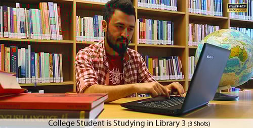 Student Works on Laptop in a Library