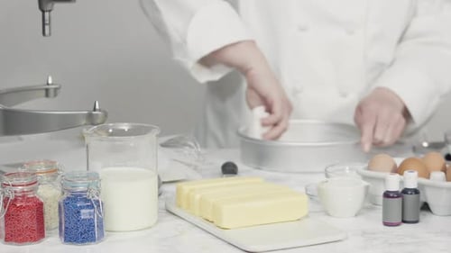 Time lapse. Step by step. Greasing cake pans with butter to bake a three-layer vanilla cake.