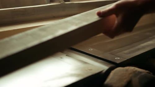 Man Operating Woodworking Machine in a Workshop