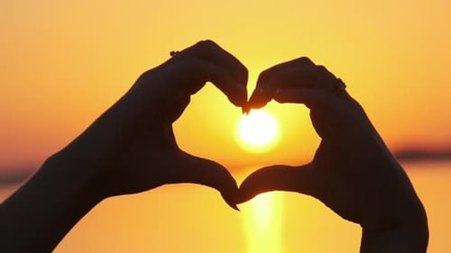 Romantic Sunset Heart Hand Gesture