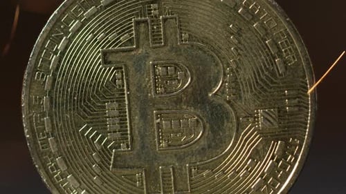 Cryptocurrency on the block chain - close up of bitcoin altcoin physical coins in dynamic setting