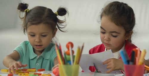 Two Children Engage in Arts and Crafts
