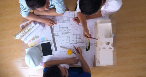 Top View Of Architects Working With Blueprint