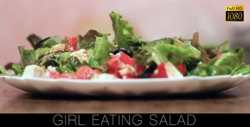 Fork Stirring Fresh Salad on Plate