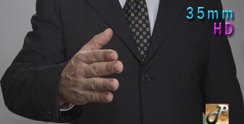 Businessman Extends Hand for Handshake in Mid Shot