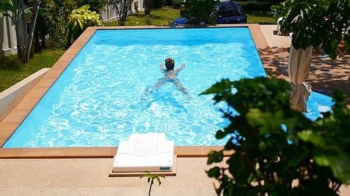 Woman Swimming in Pool in Slow Motion