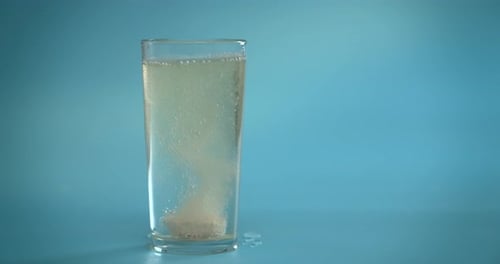 Effervescent Tablet Dissolving in Glass of Water