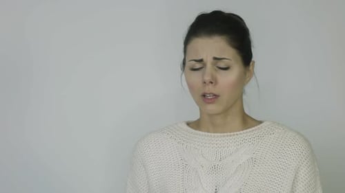 Woman Blowing Nose with Tissue Indoors Daytime