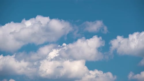 Fluffy White Clouds Floating in a Blue Sky