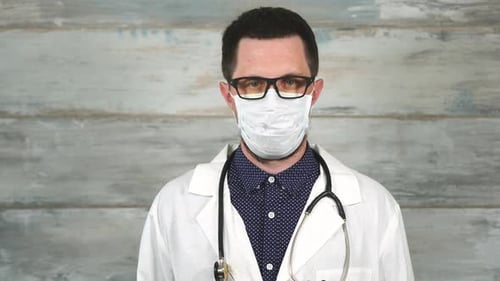 Doctor Man in a White Medical Gown and a Stethoscope on His Neck