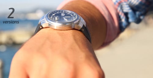 Man Checking Watch While Walking Along Ocean