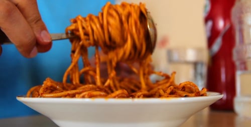 Close Up of Person Eating Delicious Spaghetti