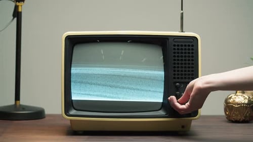 Closeup of Turning on Old Retro Television with Antenna on Grey Background Channel Setting