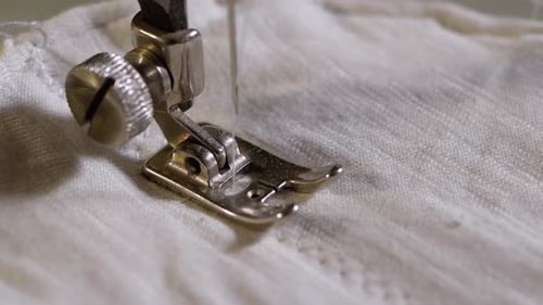 Sewing Machine Stitching White Fabric with White Thread