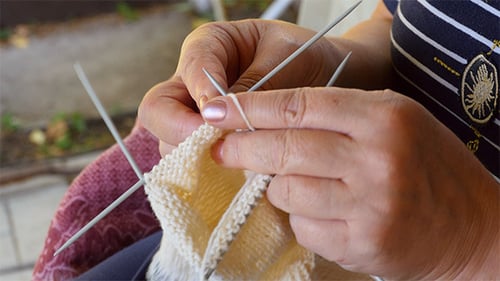 Hands Knitting Yarn with Needles Close Up