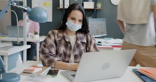 Young Business Woman Wearing Face Mask Using Laptop Typing Working in Office