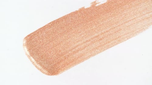 Macro Shot and Slow Motion of a Brush Applicator Smear Concealer Isolated on White Background