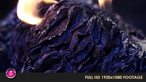 Burning Charred Paper with Flickering Flames Close Up