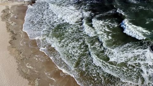 Aerial Drone View Flight Over Sea Waves That Roll Onto Sandy Shore