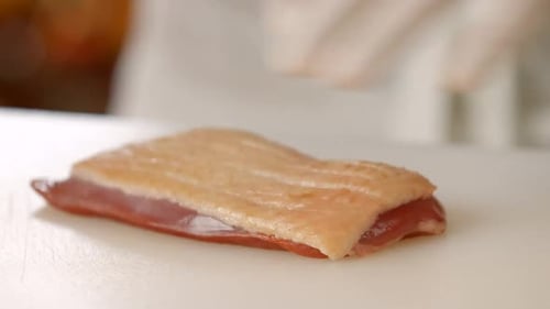 Chef Scoring Raw Meat with Sharp Knife