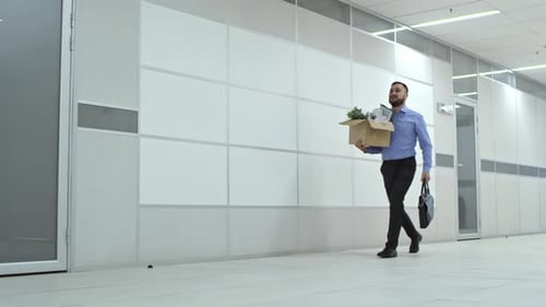 Asian Businessman Walking with Briefcase and Belongings to New Office