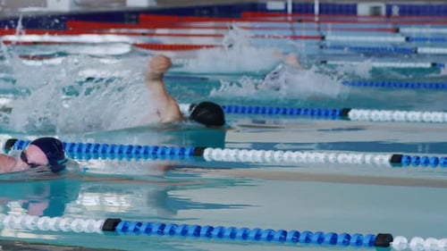 Swimmers swimming into the pool