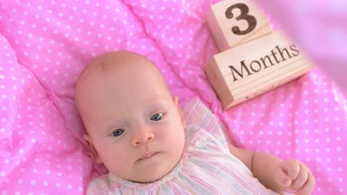 Adorable Baby Celebrates Three Month Milestone Lying Down