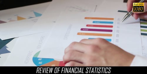 Man Analyzing Charts and Graphs in the Workplace