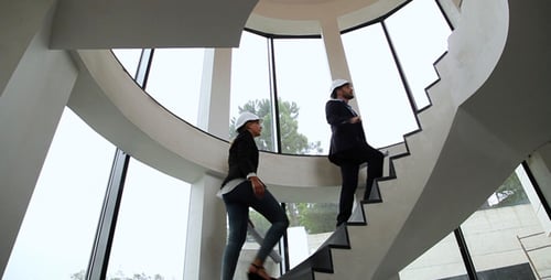 Professionals Ascend Modern Staircase in Business Attire