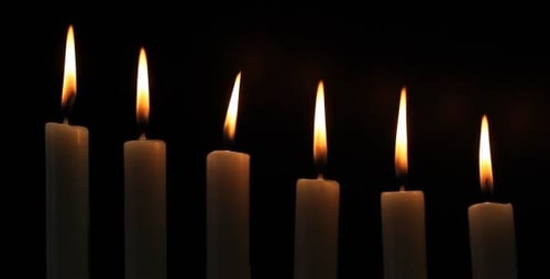 Seven White Candles Flicker in the Darkness