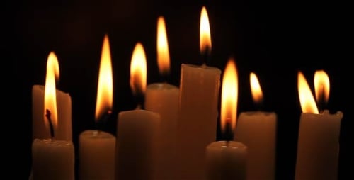 Flickering Candle Flames on Dark Background