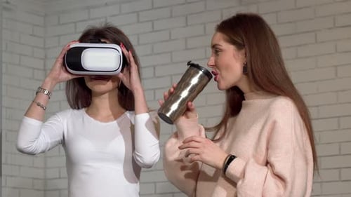 Two Women Exploring Virtual Reality Headset Together