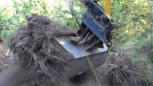 Excavator Arm Digging Dirt in Rural Environment