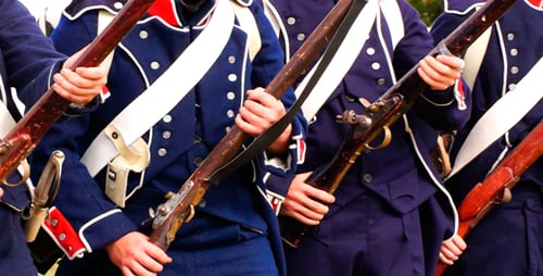 Soldiers Holding Rifles in Historical Military Uniforms