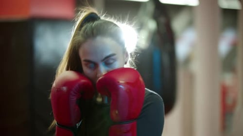 Woman Boxer Practicing Punches at Gym