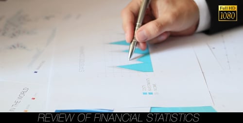 Hand Points Pen at Charts in Workplace