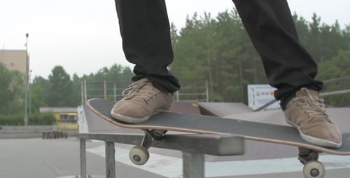 Skateboarder Grinds Rail at Urban Skate Park
