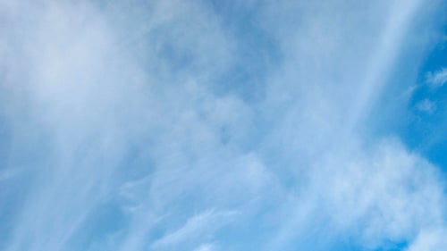 Wispy White Clouds in Azure Blue Sky