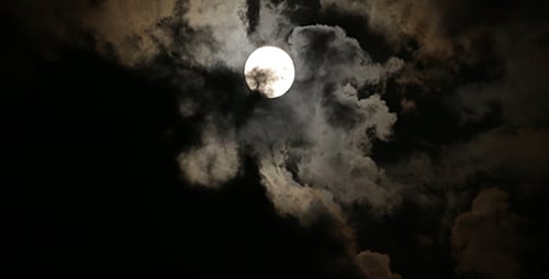 Full Moon Behind Ethereal Moving Clouds at Night