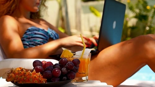 Woman Working on Laptop near Pool