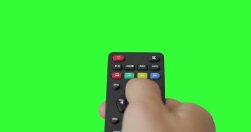 Isolated Male hand with TV remote pressing button and switch channels. Pre keyed green screen.
