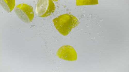 Lemon Slices Falling in Water