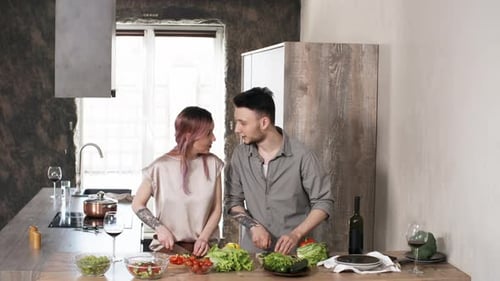 Young Couple Preparing Food Together in Kitchen